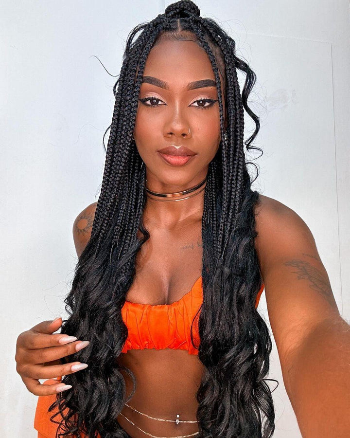 Box braids hairstyle displayed by a smiling Black woman