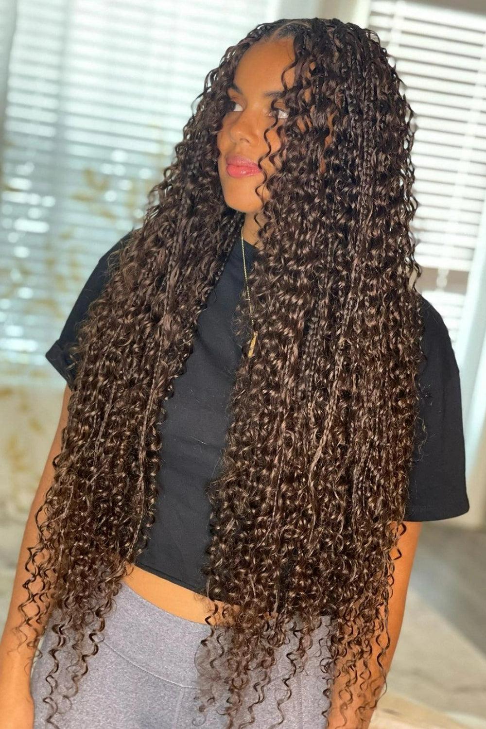 Profile view of a Black woman in black clothing showcasing color 4 boho knotless braids hairstyle