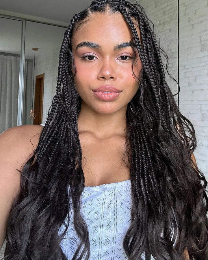 Smiling Black woman showcasing box braids hairstyle