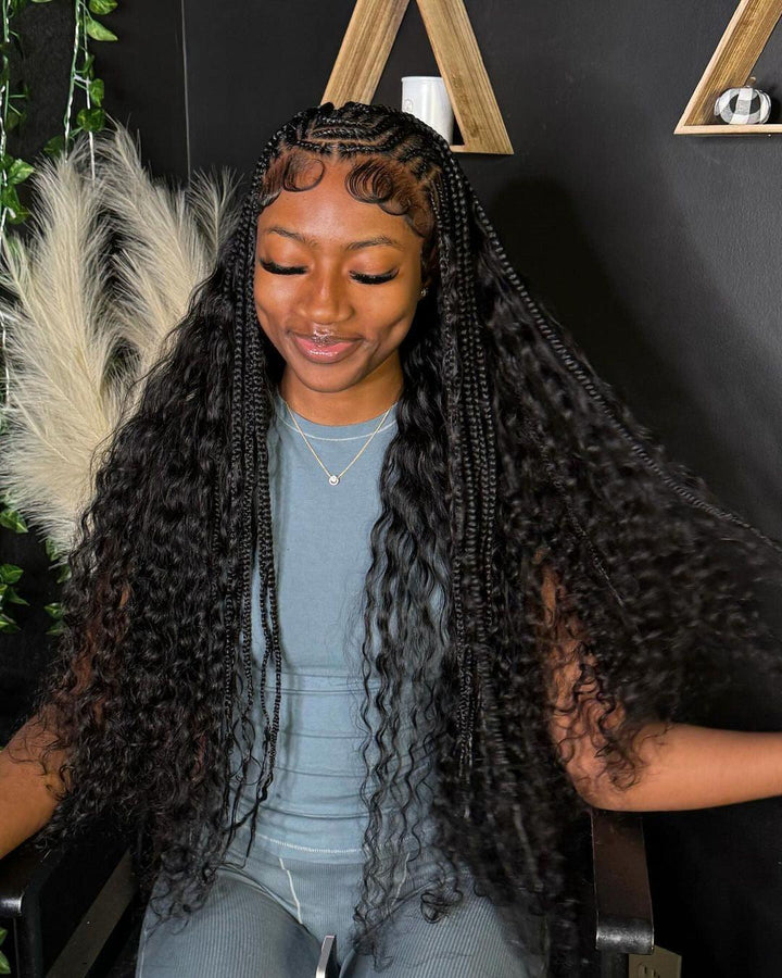 Black woman with a cheerful expression displaying boho braids